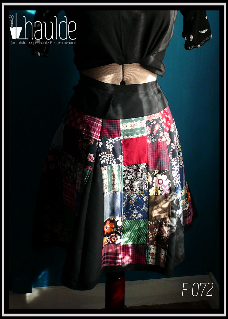 Jupe à pans amples en toile de coton noir couverte de patchwork de carrés de tissus variés tant en couleurs qu'en motifs vue de côté
