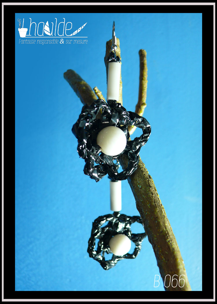 paire de boucles d'oreilles en bande video crochetée, avec au centre une perle en verre blanc