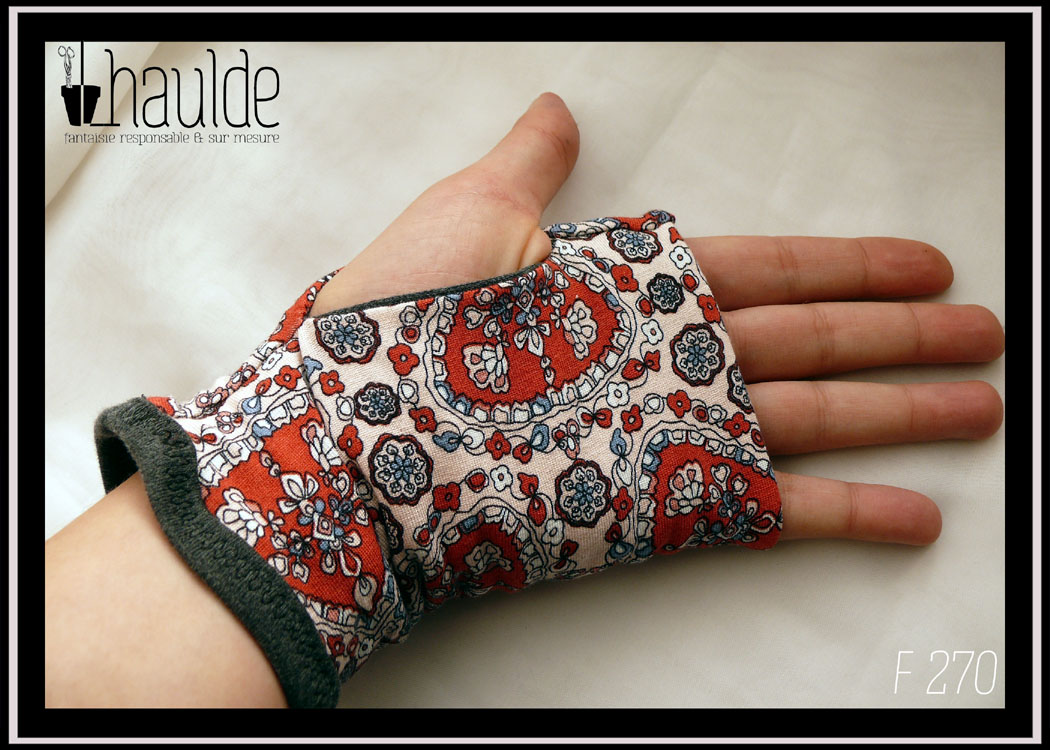 Mitaines en jersey blanc imprimé motifs végétaux stylisés rouges et bleus, manchette en jersey noir. Vue de la paume