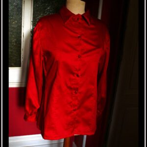 chemisier à manches longues en satin rouge cerise boutonnés de boutons de la même couleur Vu de face sur un mannequin de couture