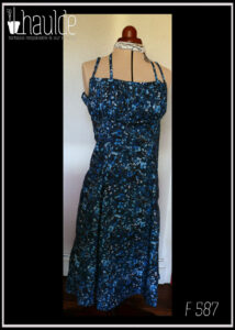 Robe mi-longue à fines bretelles (une paire classique, réglable et une paire nouée autour du cou), buste plissé, taille ajustée, jupe ample, en popeline bleu nuit imprimé petite fleurs et végétaux délicats en dégradé de bleu jean Vue de face sur un mannequin de couture