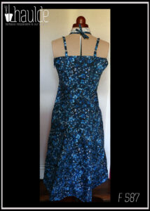 Robe mi-longue à fines bretelles (une paire classique, réglable et une paire nouée autour du cou), buste plissé, taille ajustée, jupe ample, en popeline bleu nuit imprimé petite fleurs et végétaux délicats en dégradé de bleu jean Vue de dos sur un mannequin de couture