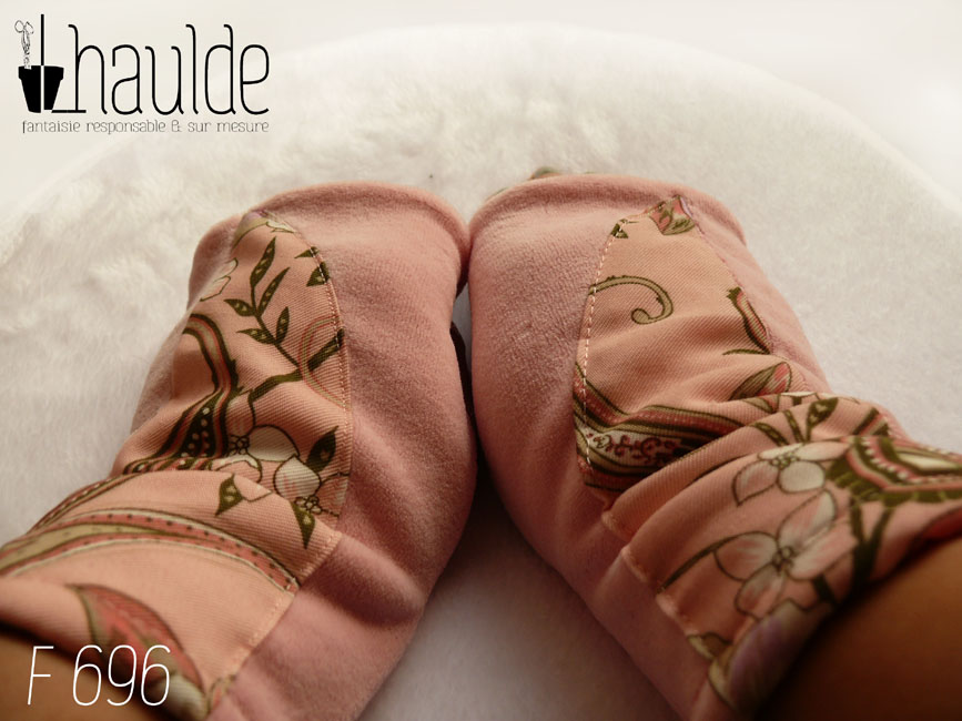 Paire de mitaines en velours rose clair avec un demi cercle de tissu rose imprimé fleurs et motifs paisley plaqué dessus Vue de la paire portée