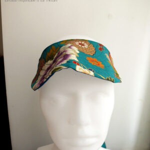 Visière à nouer en tissu bleu paon imprimé fleuri d'esthétique chinoise, dahlias et autres fleurs multicolores rehaussées de doré Vue de face sur une tête de mannequin